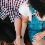 couple holding hands while sitting